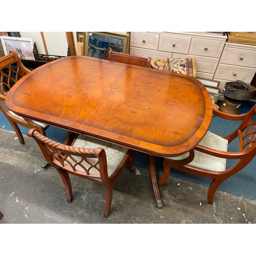 52 - YEW CROSS BANDED EXTENDING DINING TABLE AND SIX CHAIRS