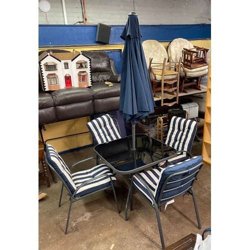 190 - GREY TUBULAR METAL PATIO TABLE AND FOUR STACKING CHAIRS WITH STRIPED CUSHIONS AND PARASOL