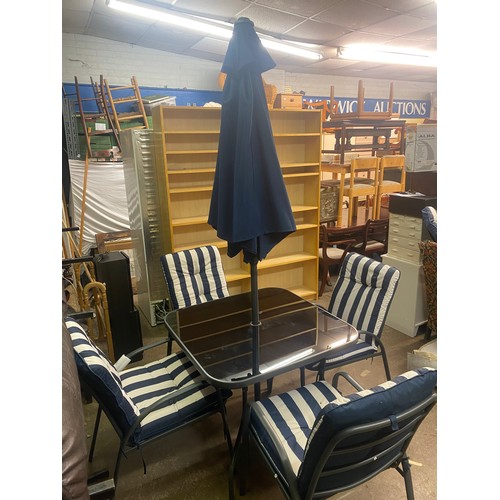 190 - GREY TUBULAR METAL PATIO TABLE AND FOUR STACKING CHAIRS WITH STRIPED CUSHIONS AND PARASOL