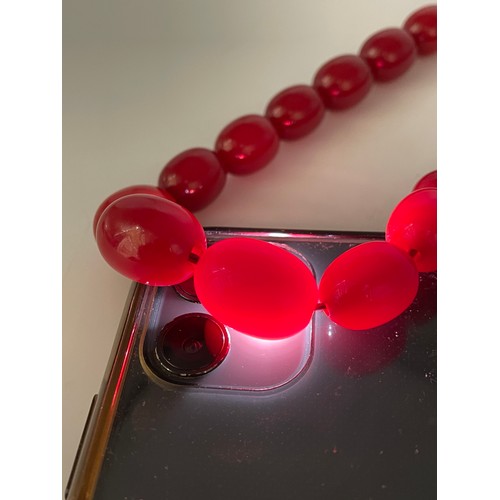 661 - STRAND OF GRADUATED RED POLISHED BEADS