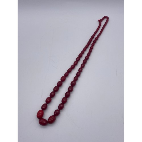 661 - STRAND OF GRADUATED RED POLISHED BEADS