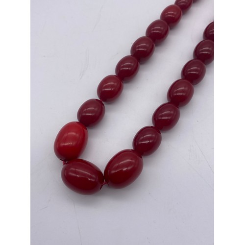 661 - STRAND OF GRADUATED RED POLISHED BEADS