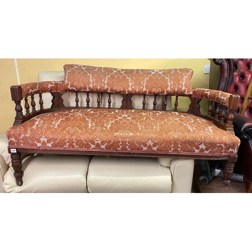 125 - LATE VICTORIAN UPHOLSTERED CURVED BACK SETTEE