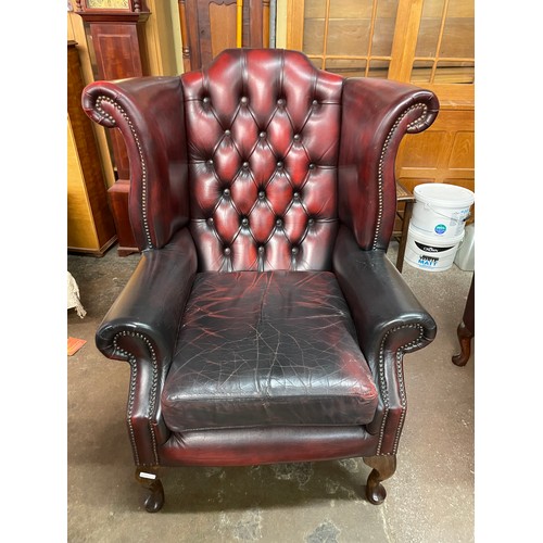 69 - OX BLOOD RED BUTTON BACK LEATHER WING ARMCHAIR