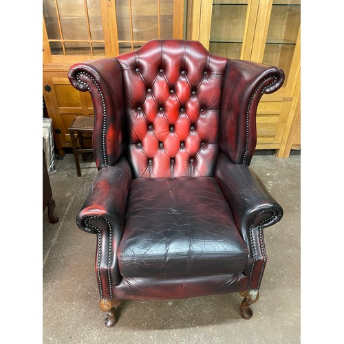 70 - OX BLOOD RED BUTTON BACK LEATHER WING ARMCHAIR