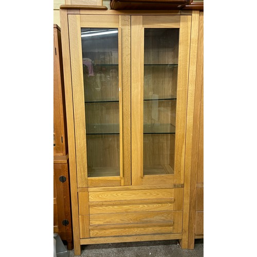 81 - CONTEMPORARY OAK DOUBLE GLAZED DOOR DISPLAY CABINET WITH BASE DRAWERS