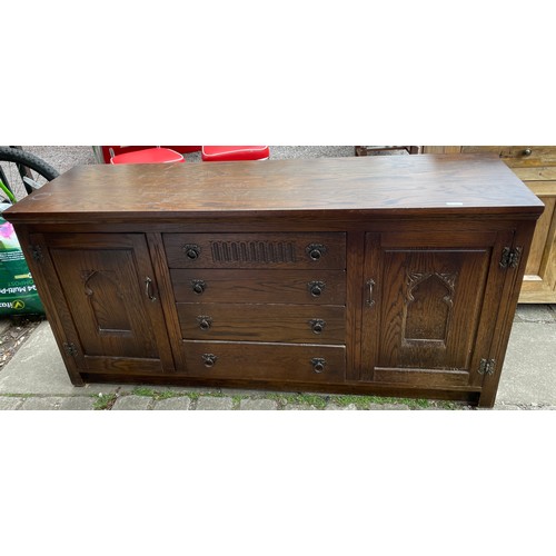 55 - OAK CARVED FOUR DRAWER SIDEBOARD