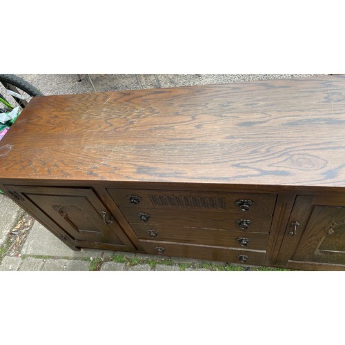 55 - OAK CARVED FOUR DRAWER SIDEBOARD