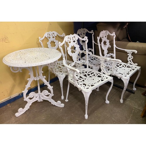 73 - VICTORIAN STYLE WHITE PAINTED CAST METAL CIRCULAR PATIO TABLE AND FOUR CHAIRS