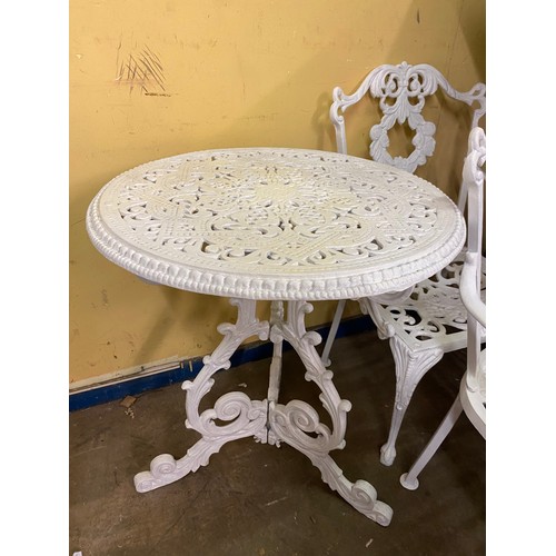 73 - VICTORIAN STYLE WHITE PAINTED CAST METAL CIRCULAR PATIO TABLE AND FOUR CHAIRS