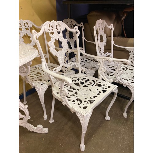 73 - VICTORIAN STYLE WHITE PAINTED CAST METAL CIRCULAR PATIO TABLE AND FOUR CHAIRS