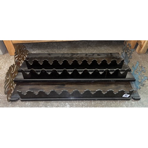 86 - THREE EBONISED FRET CARVED AND BRASS WALL SHELVES