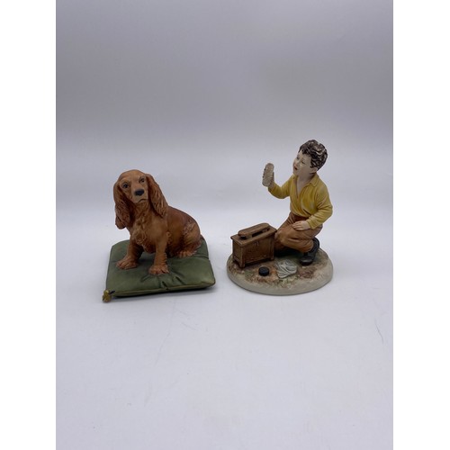 485 - CAPODIMONTE FIGURE GROUP OF SHOE SHINE BOY AND SEATED SPANIEL ON CUSHION