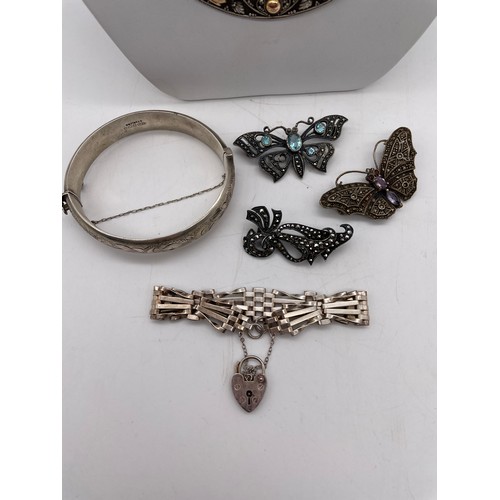 574 - SILVER ENGRAVED BANGLE, SILVER CRESCENT CHAIN, MARCASITE BUTTERFLY BROOCHES AND A FIVE BAR GATE BRAC... 