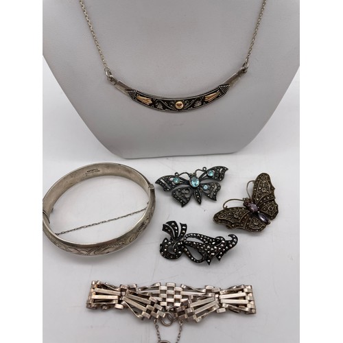 574 - SILVER ENGRAVED BANGLE, SILVER CRESCENT CHAIN, MARCASITE BUTTERFLY BROOCHES AND A FIVE BAR GATE BRAC... 