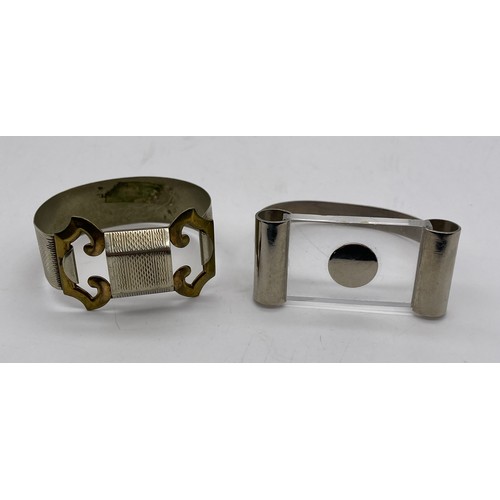 571 - METAL ENGINE TURNED BUCKLE BANGLE, AND A MODERNIST TYPE BANGLE