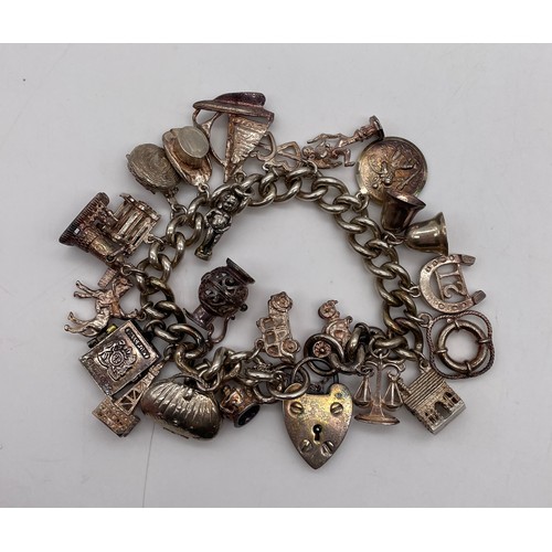 536 - SILVER CHARM BRACELET AND ASSORTED NOVELTY CHARMS