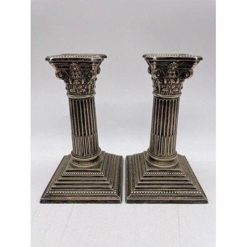 493 - PAIR OF PLATED SQUAT CORINTHIUM COLUMN CANDLE STICKS ON STEPPED BASES