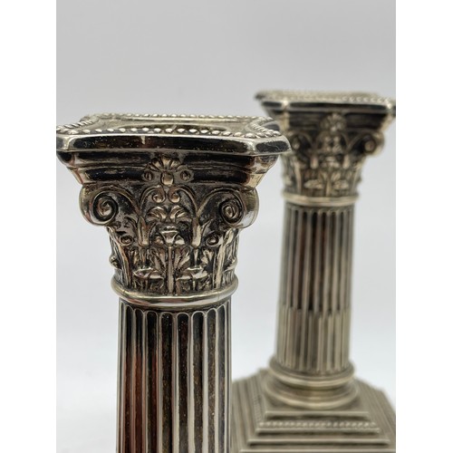 493 - PAIR OF PLATED SQUAT CORINTHIUM COLUMN CANDLE STICKS ON STEPPED BASES