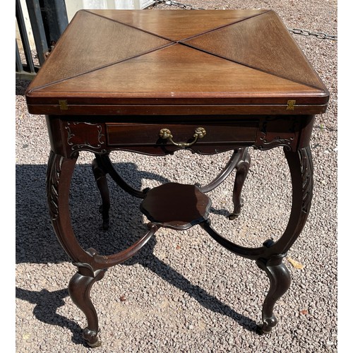 107 - EDWARDIAN MAHOGANY CARVED ENVELOPE GAMES TABLE WITH UNDERTIER