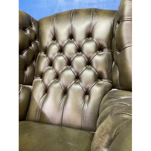 38 - BOTTLE GREEN BUTTON BACK LEATHER WING ARMCHAIR