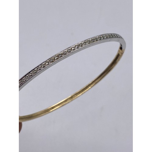 579 - 375 STAMPED YELLOW AND WHITE GOLD BANGLE 9G APPROX