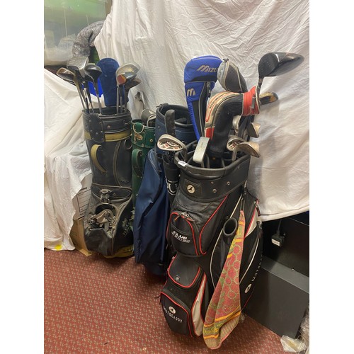 350 - FOUR GOLF BAGS CONTAINING VARIOUS GOLF DRIVERS AND CLUBS
