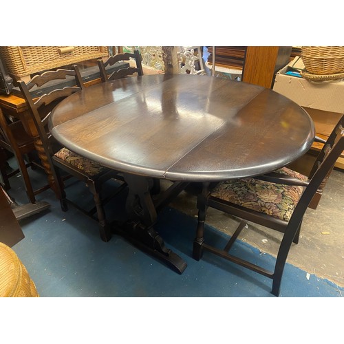 53 - DARK OAK DROP FLAP DINING TABLE AND THREE LADDER BACK CHAIRS