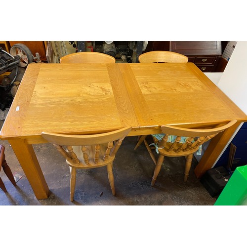 64 - OAK EXTENDING CHUNKY LEG DINING TABLE WITH FOUR SPINDLE BACK FARMHOUSE STYLE CHAIRS