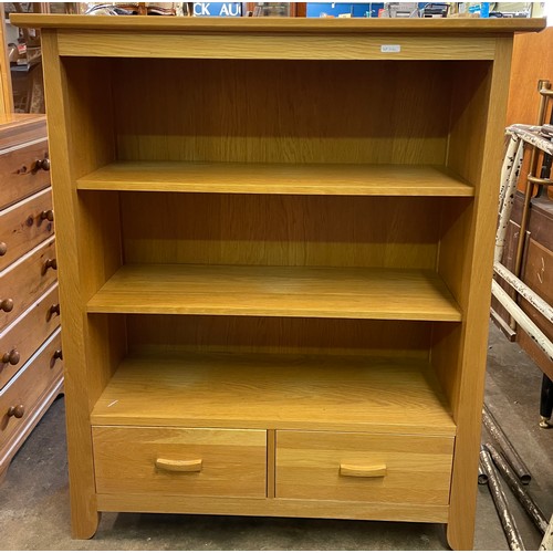 82 - OAK DWARF BOOKCASE WITH TWO DRAWER BASE