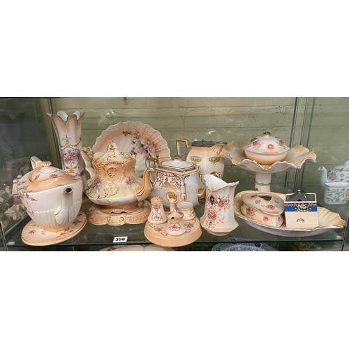 356 - CROWN DEVON BLUSH IVORY FLORAL TEAPOTS ON STANDS, CRUET SETS AND COMPORT, LIDDED JUG, SOME A/F JUG &... 