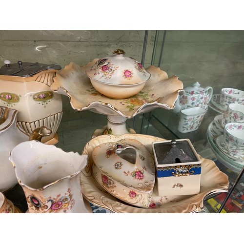 356 - CROWN DEVON BLUSH IVORY FLORAL TEAPOTS ON STANDS, CRUET SETS AND COMPORT, LIDDED JUG, SOME A/F JUG &... 