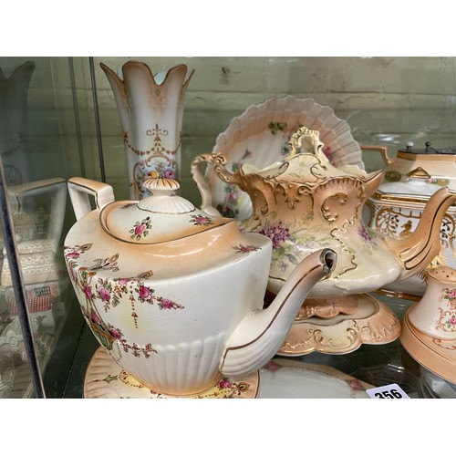 356 - CROWN DEVON BLUSH IVORY FLORAL TEAPOTS ON STANDS, CRUET SETS AND COMPORT, LIDDED JUG, SOME A/F JUG &... 