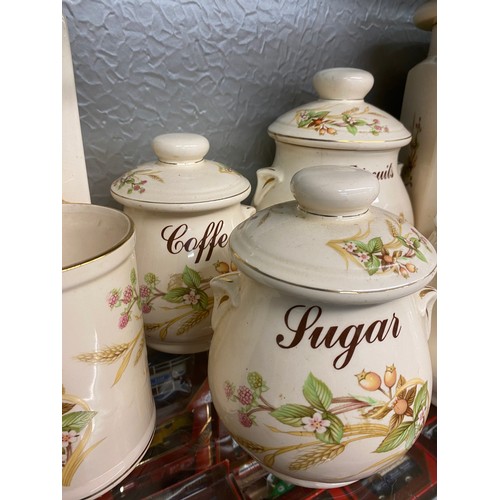 335 - STAFFORDSHIRE POTTERY BISCUIT JAR AND COVER AND OTHER KITCHEN CANNISTERS