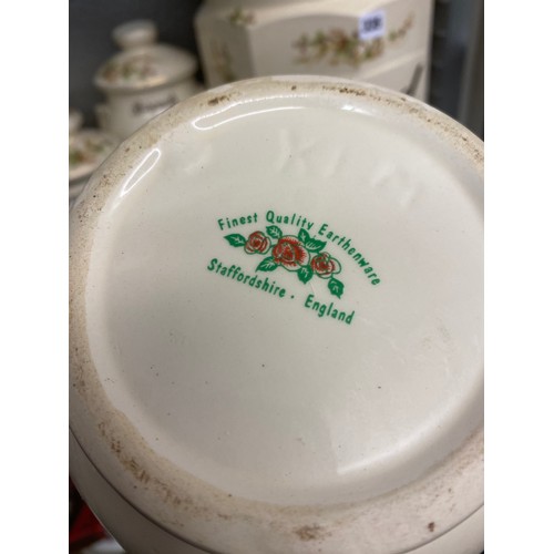 335 - STAFFORDSHIRE POTTERY BISCUIT JAR AND COVER AND OTHER KITCHEN CANNISTERS