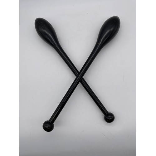 583 - PAIR OF EBONISED JUGGLING CLUBS