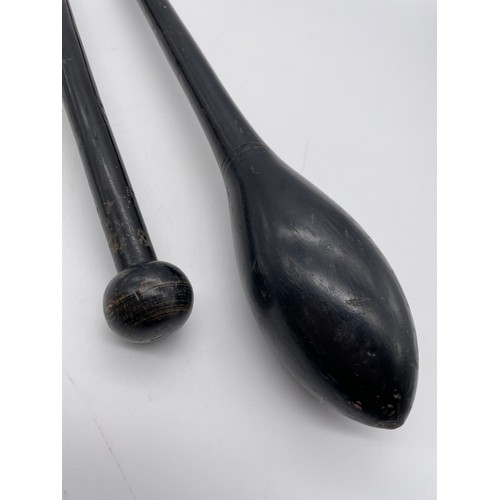 583 - PAIR OF EBONISED JUGGLING CLUBS