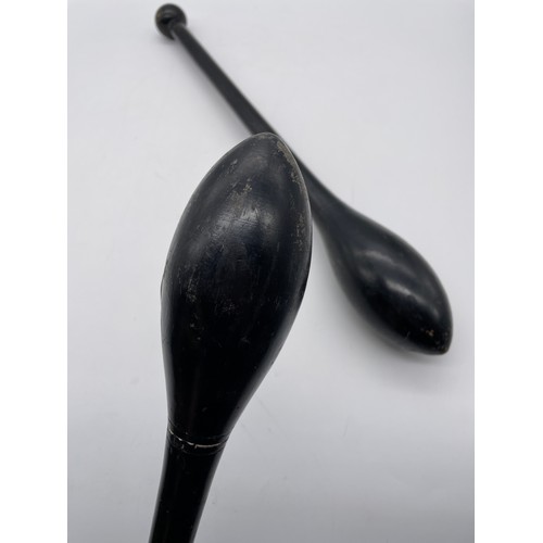 583 - PAIR OF EBONISED JUGGLING CLUBS