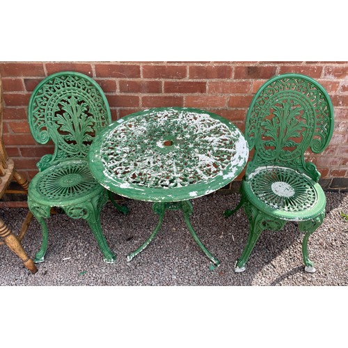 219 - GREEN PAINTED METAL VICTORIAN STYLE PATIO TABLE AND TWO CHAIRS