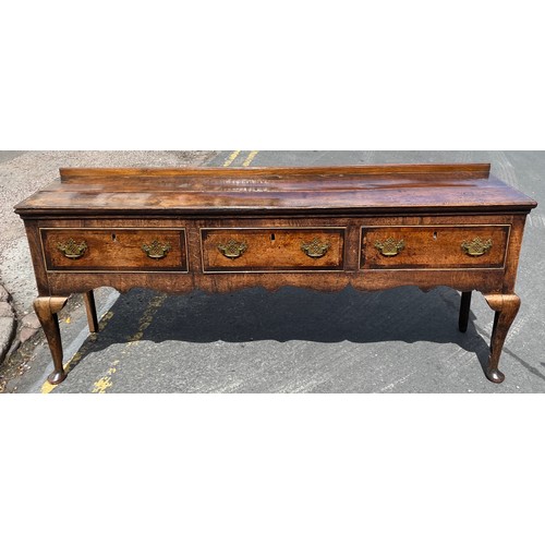 211 - MID 18TH CENTURY OAK DRESSER BASE FITTED WITH THREE CROSS BANDED DRAWERS WITH A  SHAPED APRON ON CAB... 