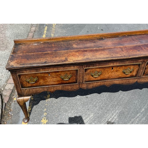 211 - MID 18TH CENTURY OAK DRESSER BASE FITTED WITH THREE CROSS BANDED DRAWERS WITH A  SHAPED APRON ON CAB... 