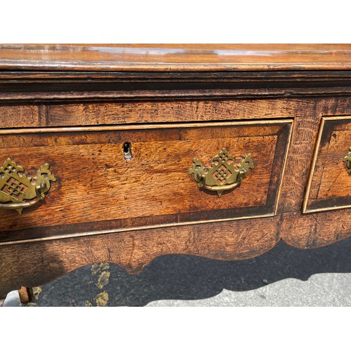 211 - MID 18TH CENTURY OAK DRESSER BASE FITTED WITH THREE CROSS BANDED DRAWERS WITH A  SHAPED APRON ON CAB... 