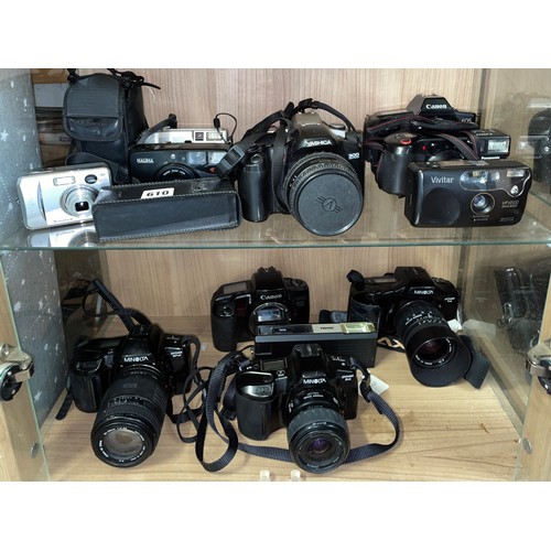 610 - TWO SHELVES OF CANON, MINOLTA, AND YASHICA CAMERAS