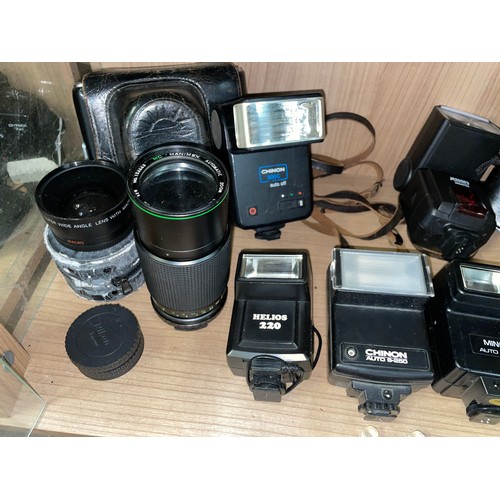 612 - THREE SHELVES OF CAMERA LENSES, VARIOUS FLASHES, AND FILTERS