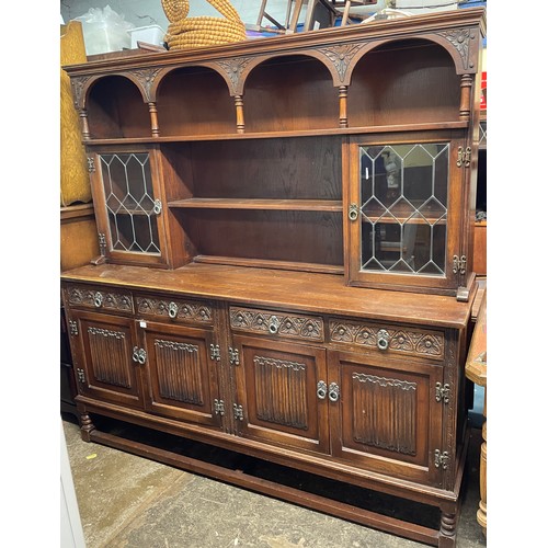 74 - OAK CARVED LINEN FOLD DRESSER WITH LEAD GLAZED RACK