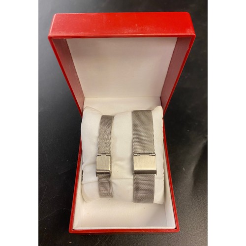 760 - BOXED ROSTINI SLIM STAINLESS STEEL HIS AND HERS WRISTWATCHES WITH MESH BRACELET STRAPS