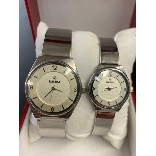 760 - BOXED ROSTINI SLIM STAINLESS STEEL HIS AND HERS WRISTWATCHES WITH MESH BRACELET STRAPS