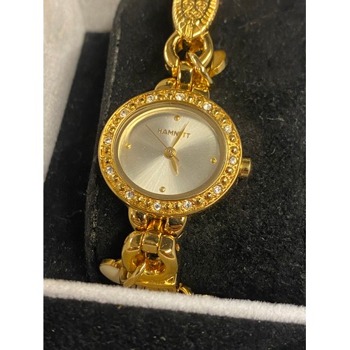 762 - BOXED HAMNETT LADIES PLATED CHARM BRACELET DRESS WATCH WITH DIAMANTE BEZEL