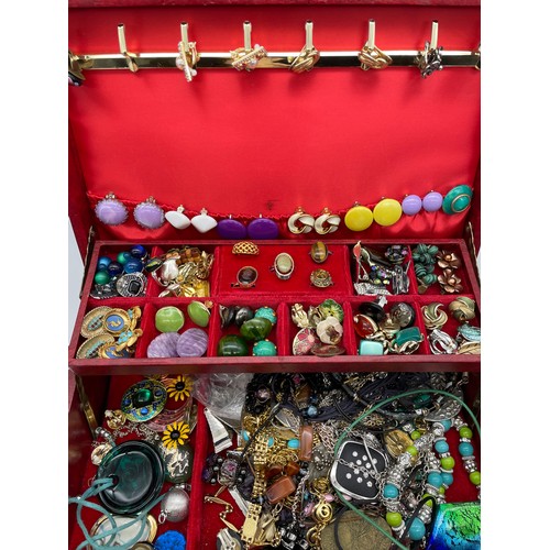 710 - RED JEWELLERY BOX WITH VARIOUS SETS OF EARRINGS, RINGS, PENDANTS AND POWDER COMPACT