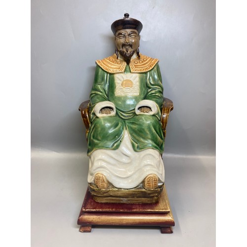 216 - CHINESE EARTHERNWARE SEATED EMPEROR FIGURE ON HARDWOOD STAND